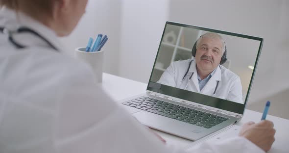 Video Conference with Head Physician of Hospital, Woman Therapist Is Listening Man at Display of Her