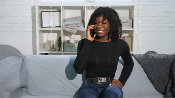 Attractive Girl in Black Pullover Talks on Modern Smartphone