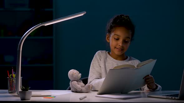 The Girl Reads a Book for Her Little Friend the Bear a Soft Toy Flicks His Nose