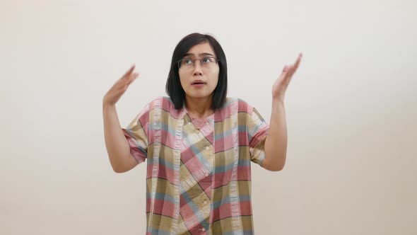 Pretty asian woman pointing fingers left and right, making decision, showing two variants choices