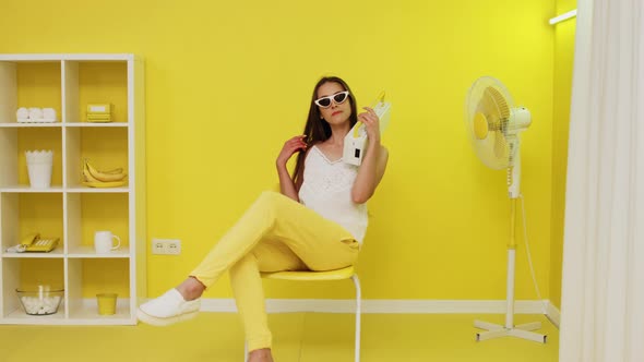 Model Is Posing On Chair With Retro Cassette Recorder