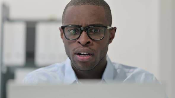 Close Up of African Man Having Loss While Using Laptop