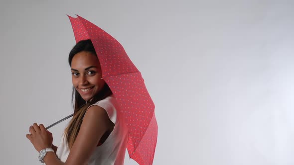 Attractive African Model Posing with Umbrella for a Fashion Magazine Photo Shoot