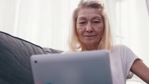 Senior Woman Talking Over the Internet with Family