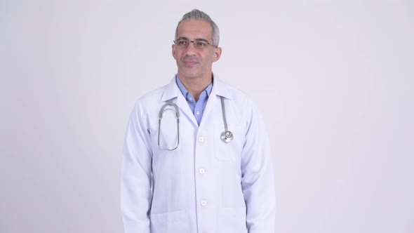 Happy Persian Man Doctor Thinking Against White Background