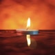 A small candle floating in the wavy water in the darkness - VideoHive Item for Sale