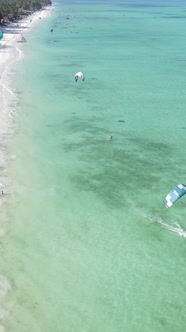 Vertical Video Kitesurfing Near the Shore of Zanzibar Tanzania