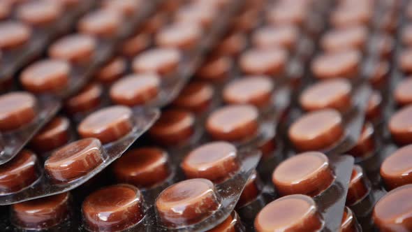 Rotating shot of brown color tablets on a white table