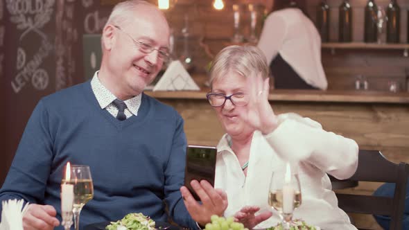 Senior Couple on a Date Having a Video Call with Their Children