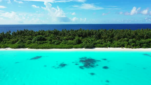 Natural above copy space shot of a sandy white paradise beach and blue water background in hi res 4K