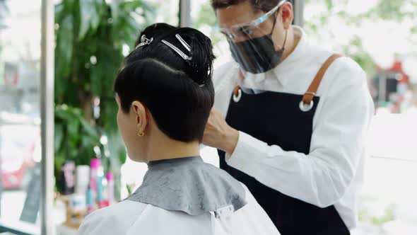 Happy small business owner at a hairdressing studio during COVID-19.