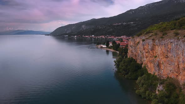 Aerial (drone) dolly forward shot of Macedonian shore in Ohrid Lake, Pesztani and Trpejca