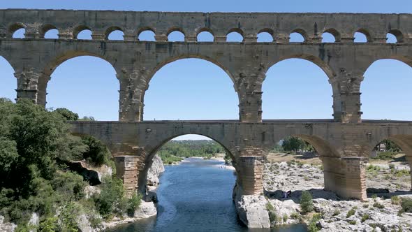 Low angle aerial shot of The Pont du Gard, an ancient Roman aqueduct in France