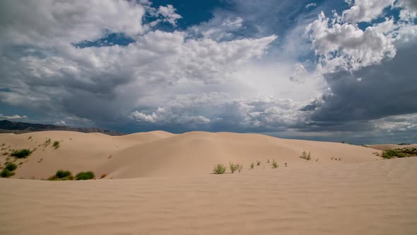 Timelapse looking over the sand dunes as a summer storm rolls over the landscape