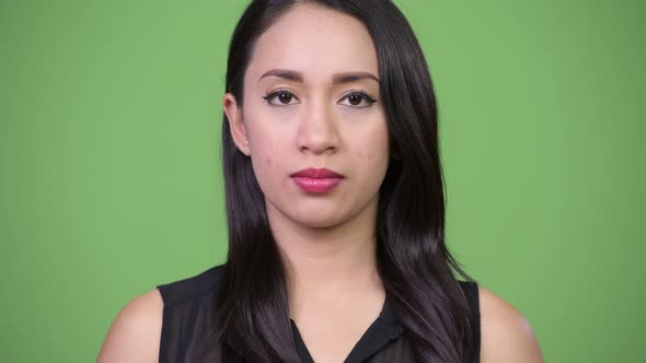 Young Beautiful Asian Businesswoman Against Green Background