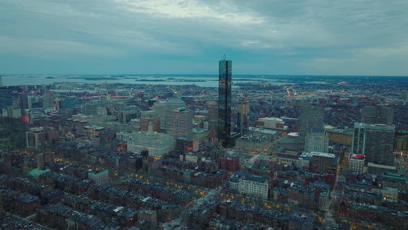 Aerial Panoramic Footage of Modern Tall Skyscraper and Surrounding Downtown Buildings