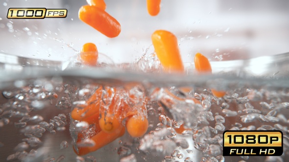 Baby Carrots Falling into Pot with Boiling Water