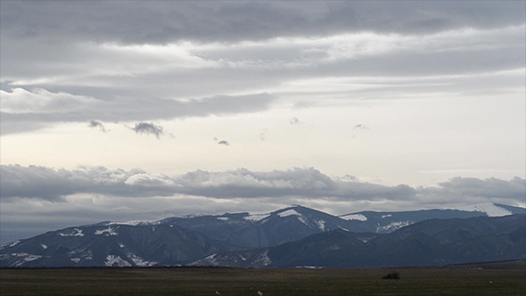 Grey Clouds Over Snowy Mountains Time Lapse