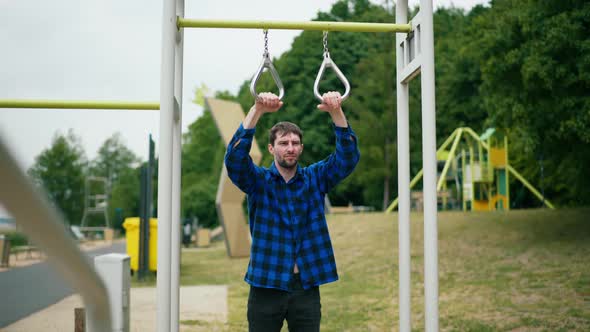 Young Strong Man Exercising on the Beach