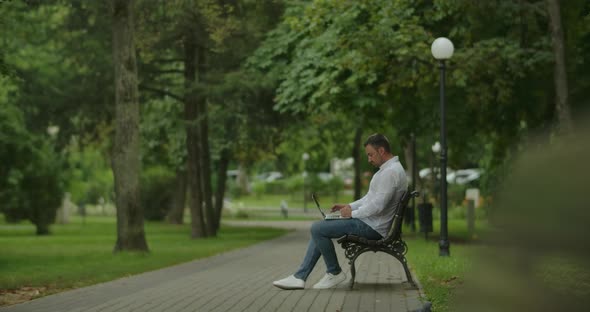 Freelancer With Laptop In The Park