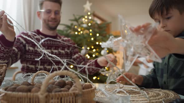 Dad with son trying to untangle the cable with the light. Shot with RED helium camera in 8K