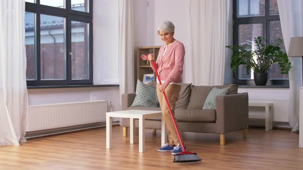 Old Woman with Broom Sweeping and Cleaning Floor