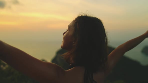 Thailand's Sunset Bokeh Woman Rise Up Hands to Sky Looks on Green Grass Thai Isles at Ocean Bay