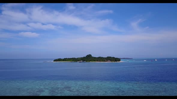 Aerial flying over seascape of luxury bay beach lifestyle by blue green water with white sand backgr