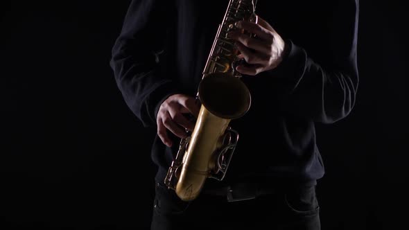 Blues on the Saxophone. Musician Playing Solo in Black Studio