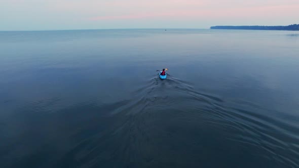 Young Man Kayaking in Calm Lake. Aerial View Tourist Floating on Canoe in Se