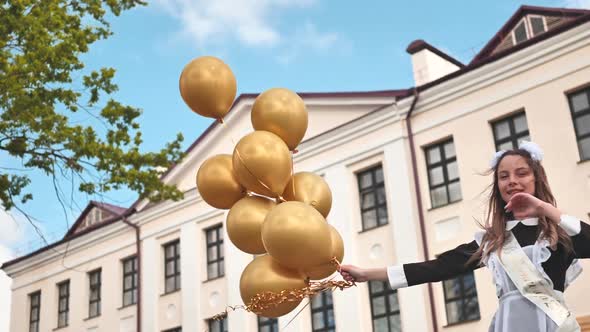 Happy Russian Schoolgirl with Balloons on Graduation Day