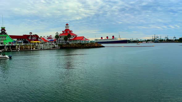 Panning right shot of the light house and the harbor of Shoreline Village in Long Beach Ca with a bo