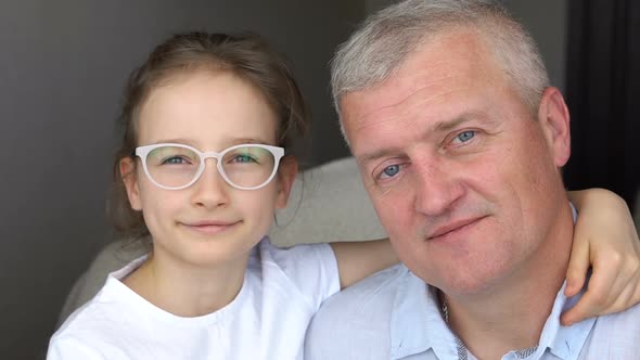 Handsome Father and Cute Daughter are Looking at the Camera Happy Family Togetherness Father's Day