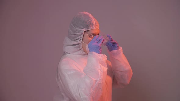 Professional Female Doctor in Mask Standing in Hospital Room Putting Glasses On, Health Care Concept