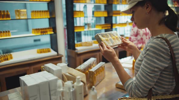 Young girl choosing a perfume in a store