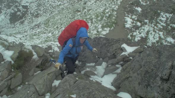 rocky alpine peaks, landscape of a slovakian tatra mountains, woman or female hiker hiking with back