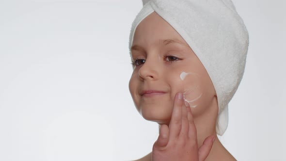 Lovely Young Child Girl Applying Cleansing Moisturizing Face Cream Skincare Natural Creme Cosmetics