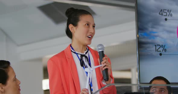 Female speaker addressing the audience at a business conference