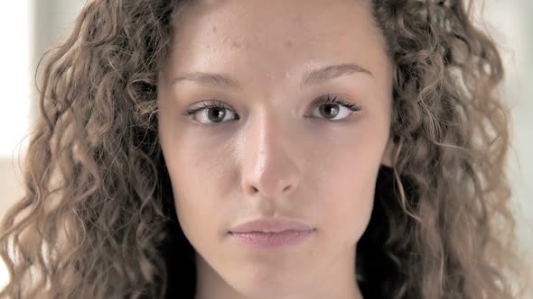 Face Close Up of Serious Curly Hair Woman