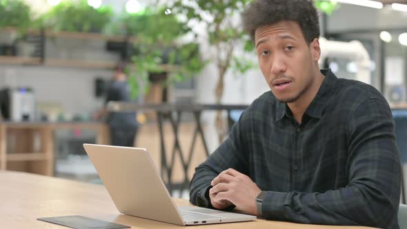 Thumbs Up By African American Man with Laptop at Work