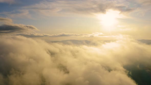  Fly through the Clouds Above Mountain at Sunset. Flying Over Fog at Sunrise in Spring