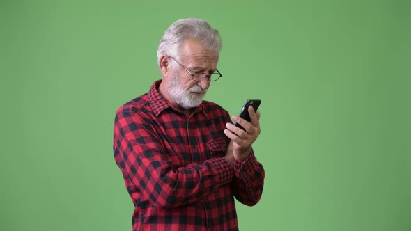 Handsome Senior Bearded Man Against Green Background