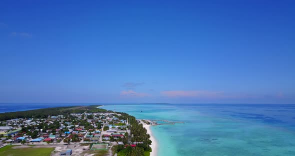 Tropical fly over tourism shot of a summer white paradise sand beach and aqua blue water background 