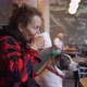 Side View of Young Woman Drinking Coffee and Hugging and Kissing Her Brown and White Adorable Dog  - VideoHive Item for Sale