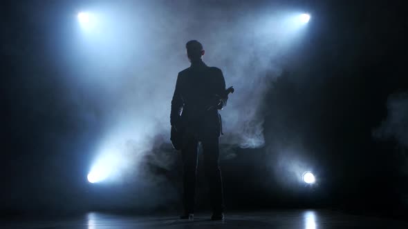 Man Playing a Slow Tune on the Guitar. Smoke Studio