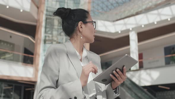 Asian Businesswoman Using Tablet Indoors