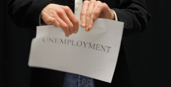 Businessman Tears Up Unemployment Sign