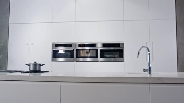 Tracking shot of a luxury kitchen with white modern design