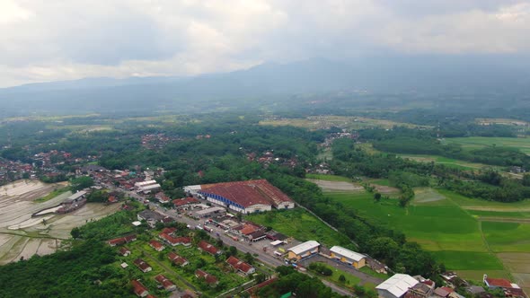 Industrial area in verdant landscape of Grabag, Indonesia. Aerial forward