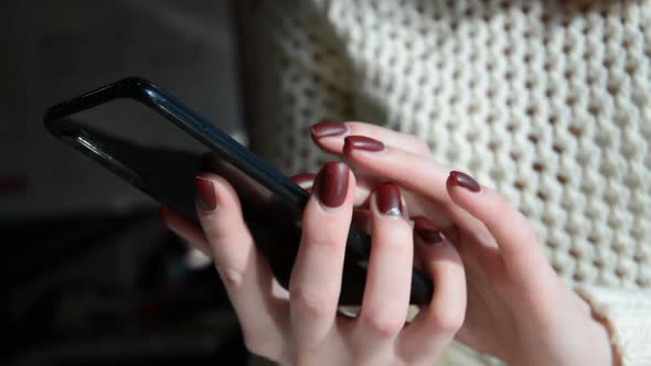 Hand of Girl Using Smartphone